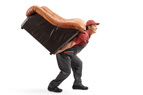 A person lifting a sofa